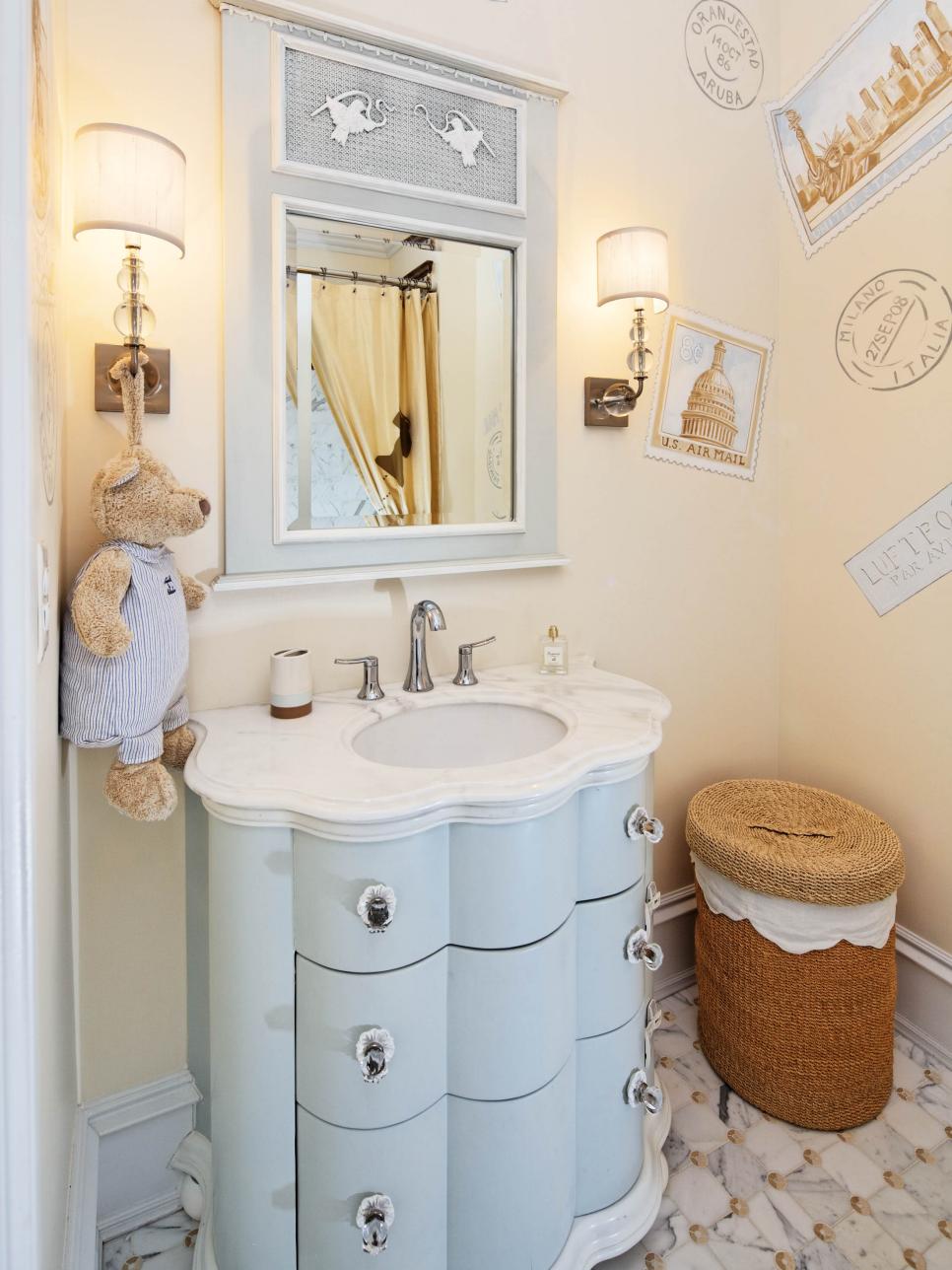 Neutral Bathroom With Blue Vanity, Sconces and Wall Decals