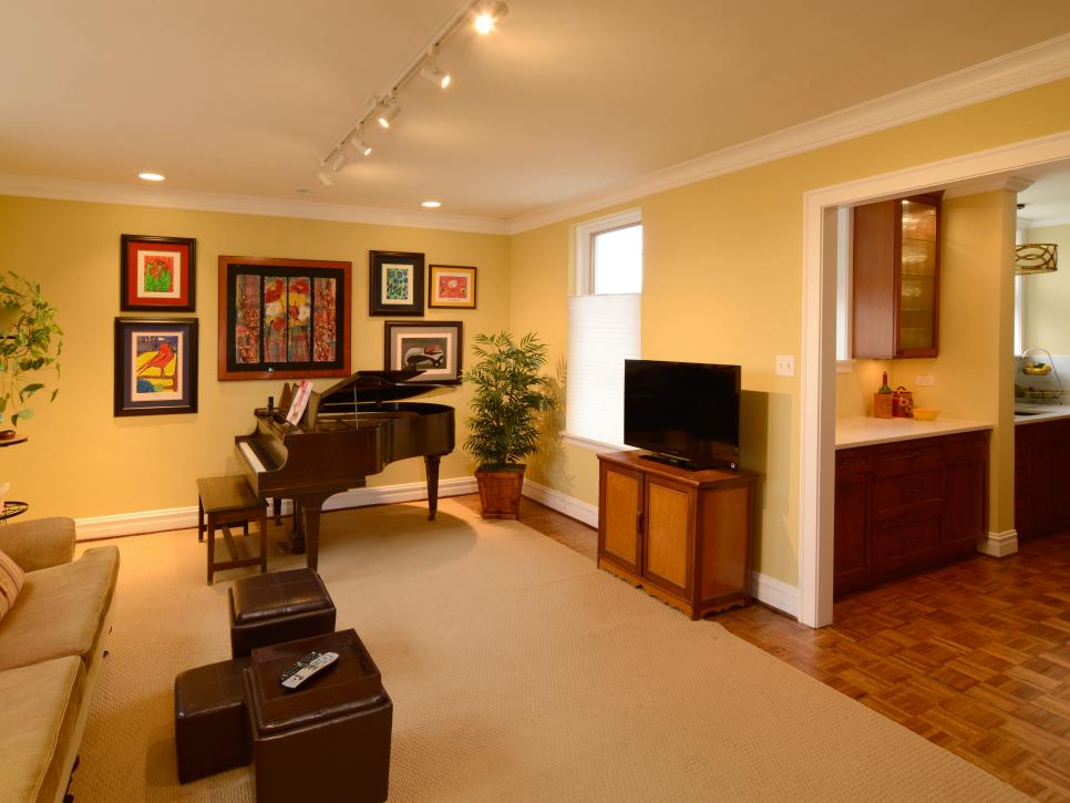 Yellow Family Room With Large Beige Area Rug, Piano and Colorful Art