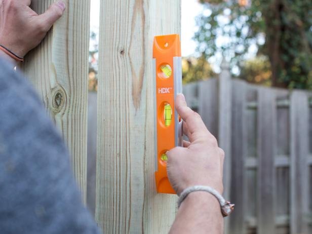Step 9: Ensure Swing Cross Beam is LevelUse torpedo level to ensure cross brace is level with ground. TIP: If not level, attach scrap 2x4s to bottom of vertical posts, shifting placement until perfectly level, then secure with exterior screws.