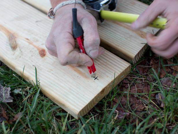 Measure, Mark and Attach Exterior Lag Eye Screws to Swing SeatUse measuring tape and pencil to measure and mark placement of exterior lag eye screws along swing seats.