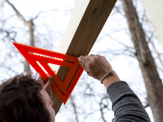 Standing on ladder, use measuring tape to determine exact width of crossbeam starting from the inside edge of each of the support beam.