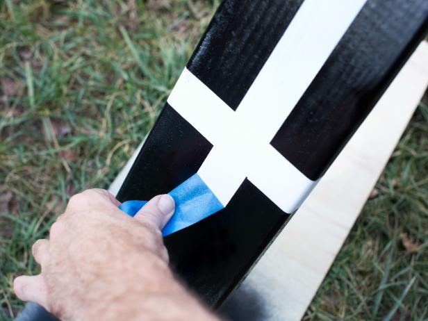 Tape off screw swing hardware with painter's tape or remove it completely to avoid paint coverage. Using roller handle and roller sleeve, paint all wooden surfaces with two layers.