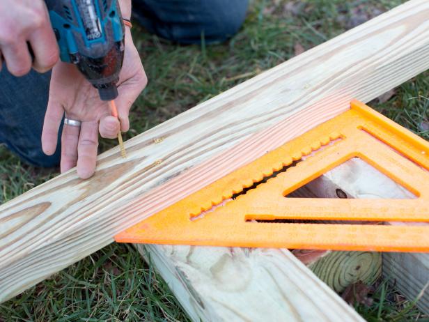 In order to keep vertical posts perfectly level and evenly spaced apart, footers will need to be cut and attached along the bottom of coupled 4x4s.