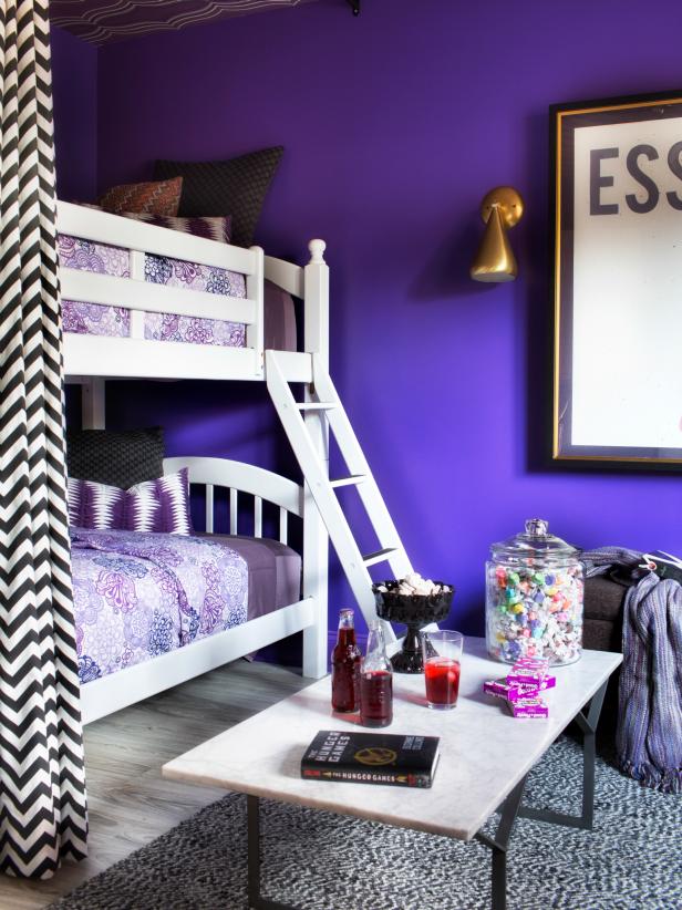 A basic bunk bed is given designer flair with the addition of ceiling-mounted hardware, floor-to-ceiling drapery panels and a fresh coat of paint in this teen girl's bedroom.