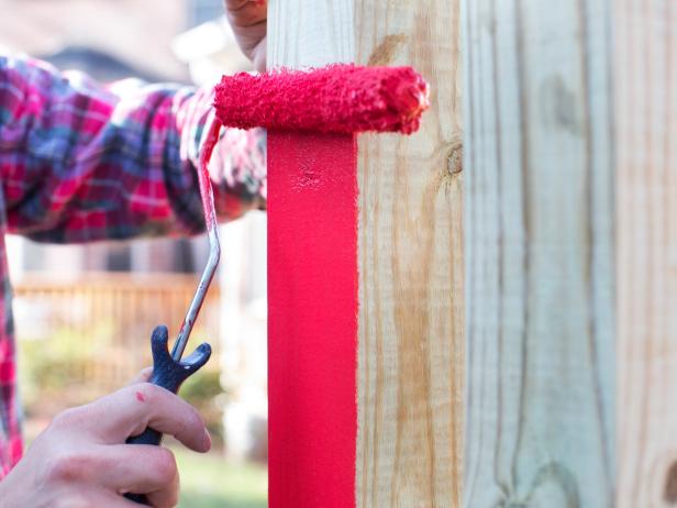 Tape off screw swing hardware with painter's tape or remove it completely to avoid paint coverage. Using roller handle and roller sleeve, paint all wooden surfaces with two even coats of exterior paint.