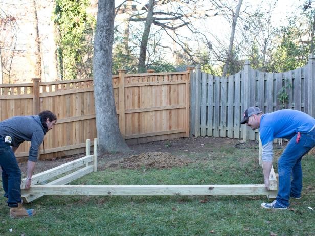 With the help of two or three friends, lift structure and place into holes.