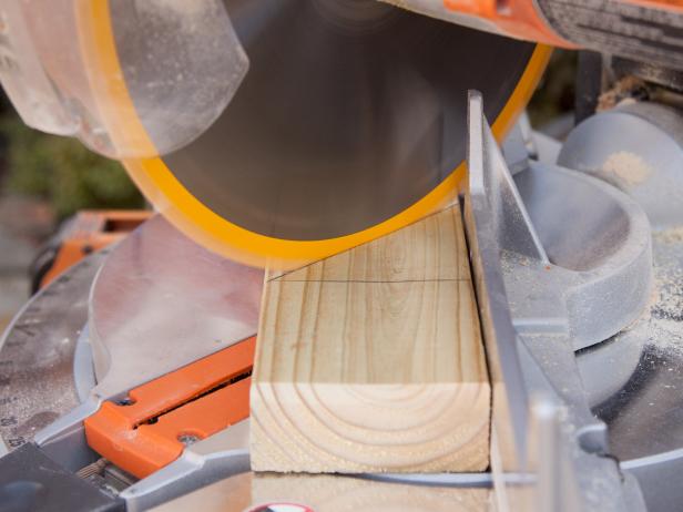 Use chop saw set to 45-degree angle configuration to create proper shape needed for a spike. Repeat 3 times for a total of 4 spikes.