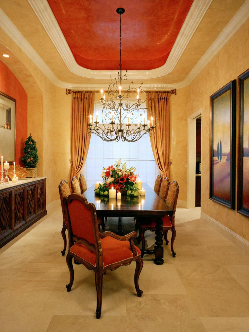 Orange and Ochre Dining Room with Tray Ceiling and Chandelier