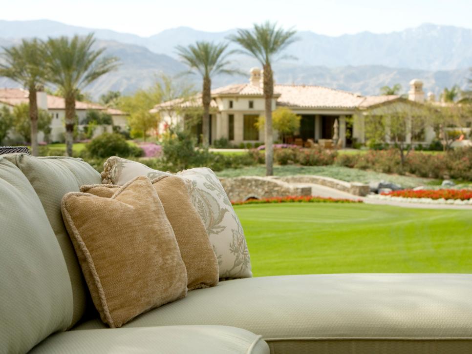 Sage Green Outdoor Sectional with Neutral Throw Pillows 