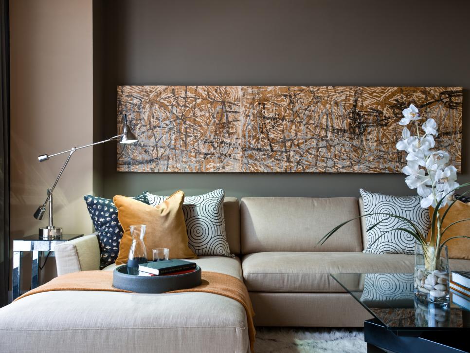 Brown Living Room With Horizontal Abstract Art and Beige Sectional