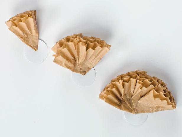 Attach folded coffee filters to a 2-inch card-stock circle using hot glue, overlapping them as you go until the circle is full.