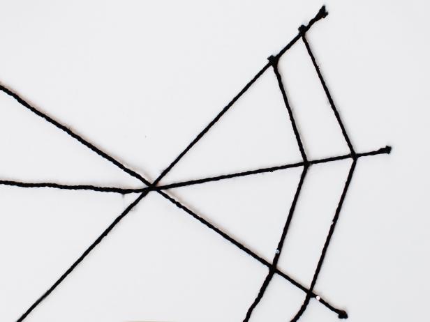 Continue with the glue dots in the same pattern, using a separate piece of yarn for each new part of the web.