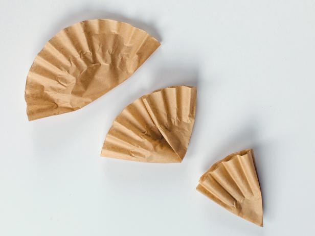 Fold each coffee filter into a pie-slice shape by folding it first in half, then into thirds