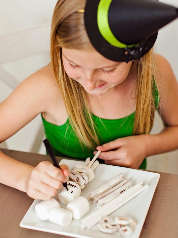 Using an edible-ink marker, add a face to the top marshmallow. Use your imagination and make it spooky or friendly looking.