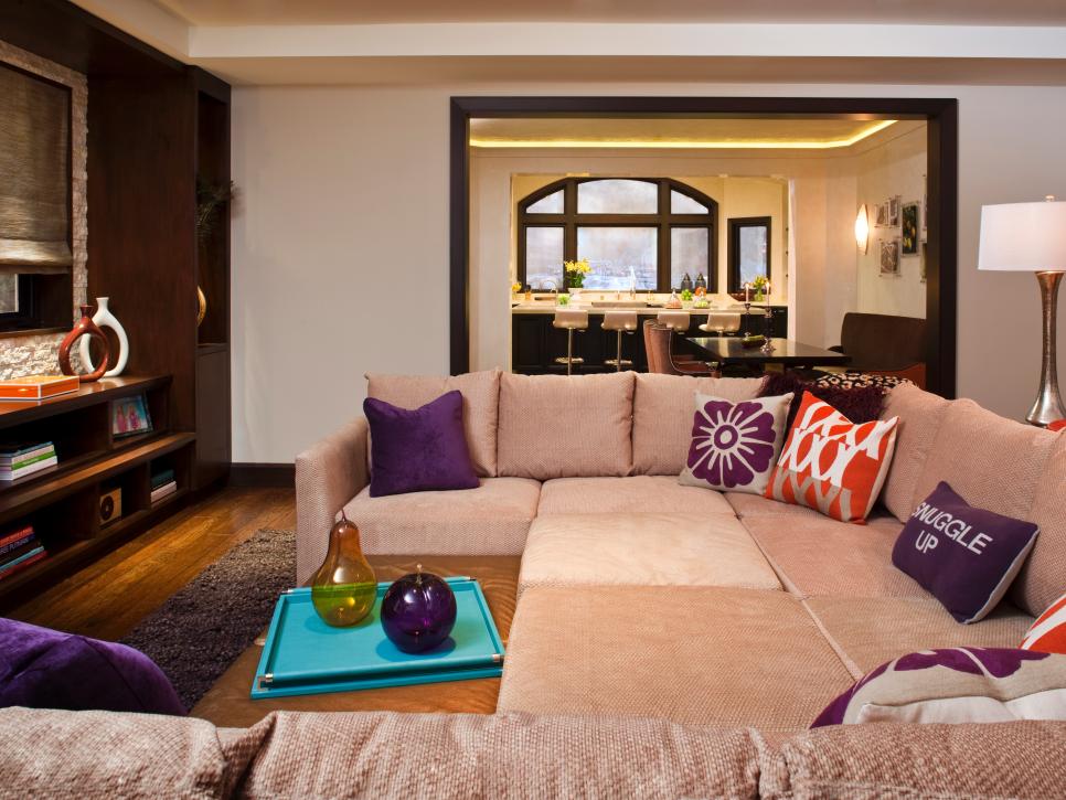 Neutral Family Room With Tan Sectional and Purple Pillows