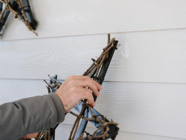 Using a basic picture nail and hammer (or adhesive wall hooks), hang the star to exterior of house.