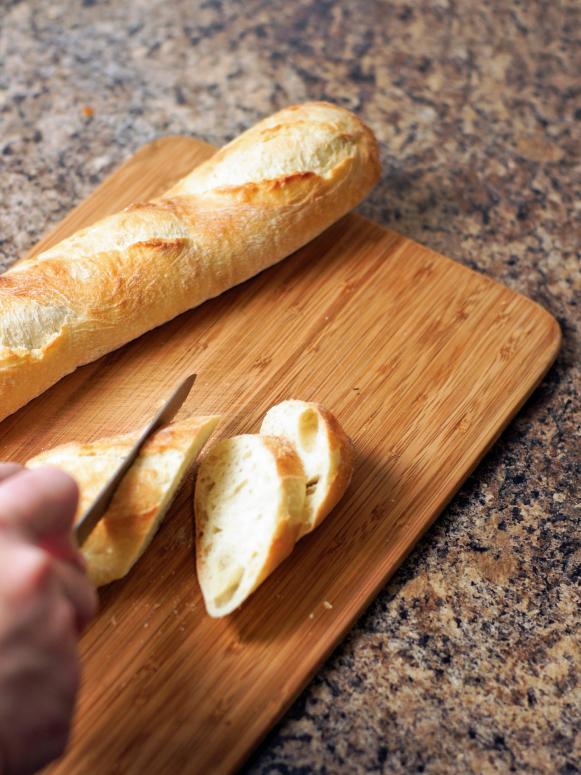 Slicing French Bread on Cutting Board Slicing French Bread on Cutting Board