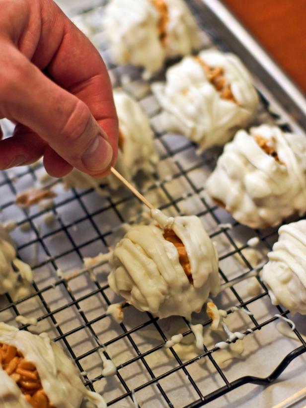 In step 4, after all of the mounds are covered, start over by placing just a dot for each of the eyes in the spaces you left. Insert a mini chocolate chip upside down in each dot of white chocolate while it is still soft.