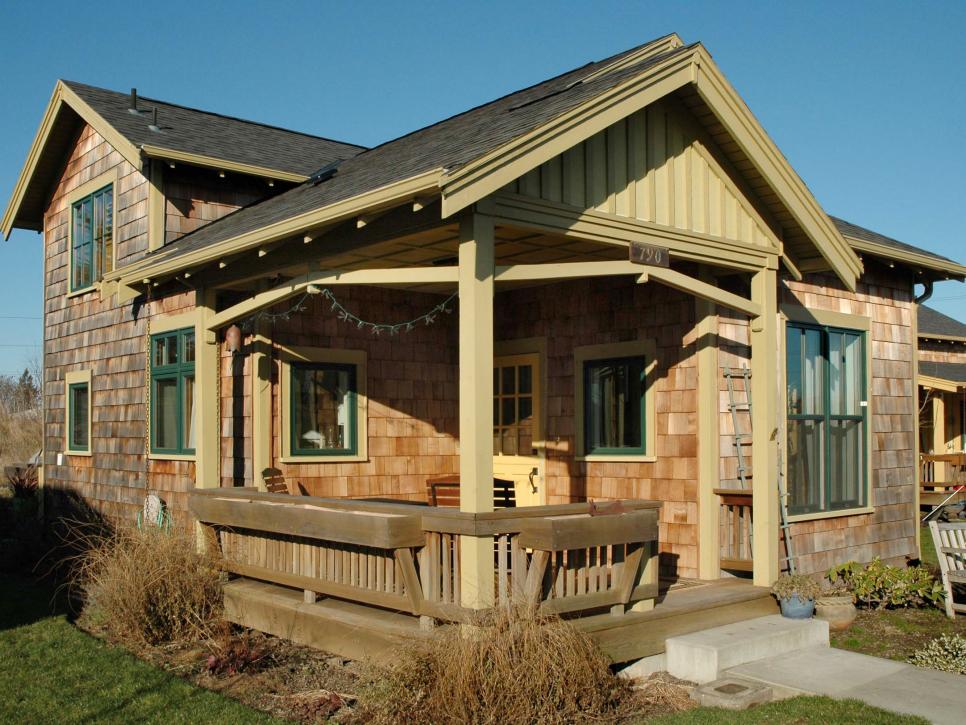 Country-Style Home With Wood Shingles and Green Windows Exterior of Country House With Wood Shingle Siding and Green Accents