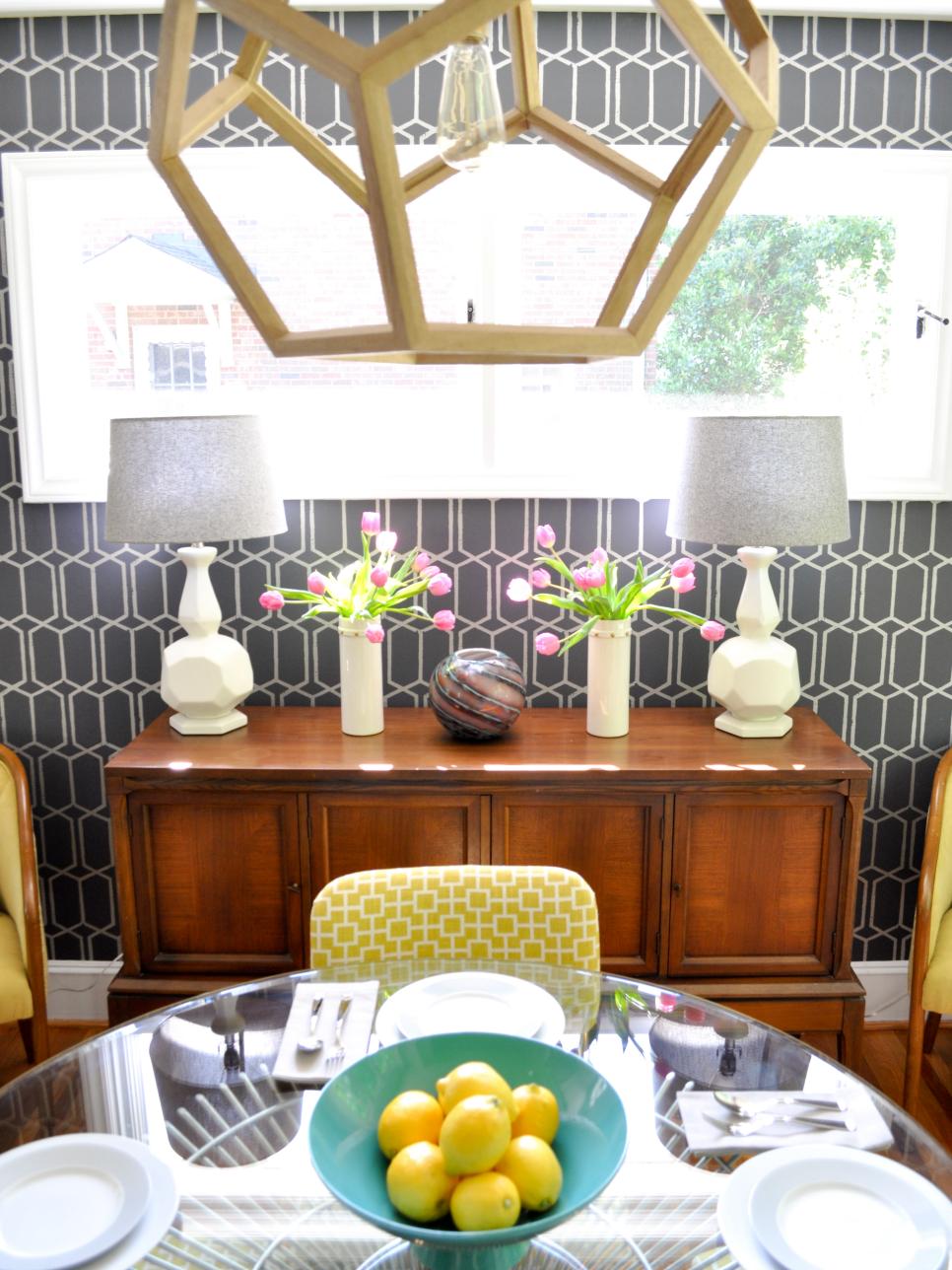 Graphic Gray Wallpaper in Midcentury Modern Dining Room Gray Dining Room With Printed Wallpaper, Wood Buffet, White Lamps