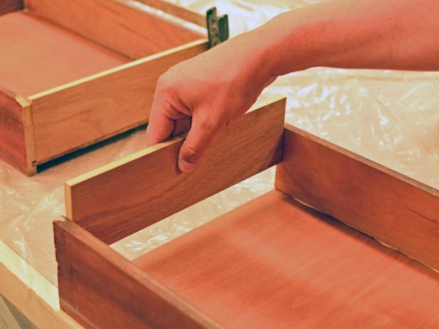 Vintage dresser drawers are reassembled for use in a DIY bathroom vanity.