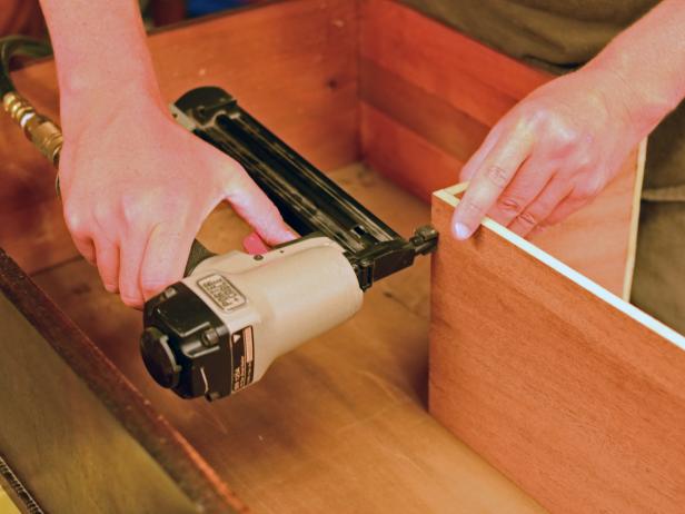 Reassembled drawers are nailed in a DIY bathroom vanity.