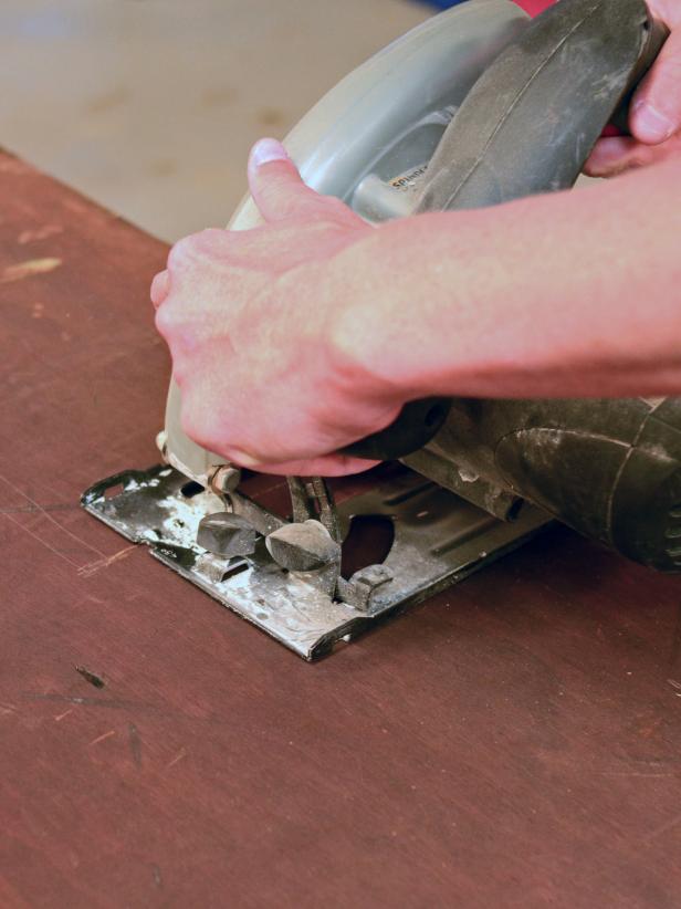 The top of a vintage dresser is cut to prepare for sink installation.