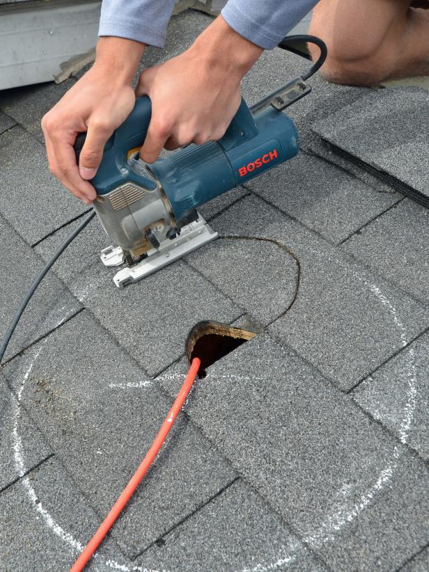 Cut along circle with a jigsaw. (In the case of this installation a small hole was cut to accommodate a plug for jigsaw, but this is not necessary.) Tip: Wear shoes with good treads like hiking boots, work boots or trail running shoes when working on a roof.