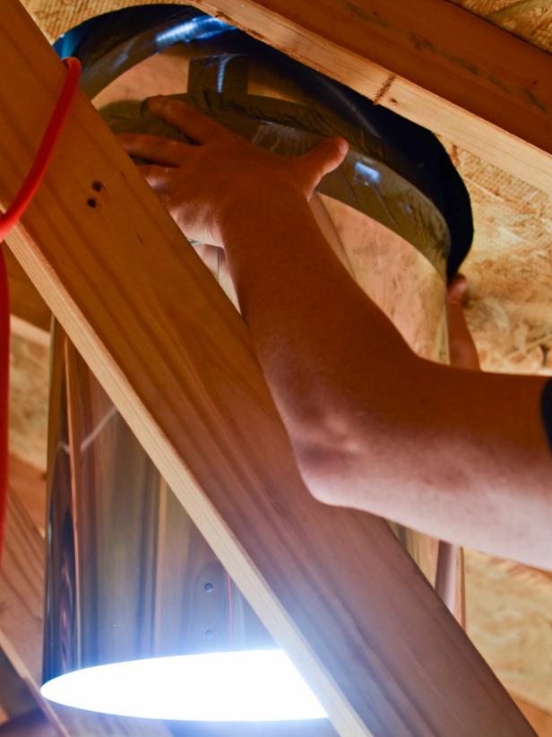 When installing top (roof) portion of skylight tube, have assistant work inside attic to help with lowering tube into position.