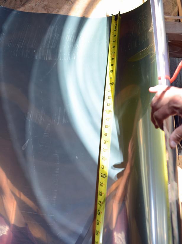 Use tape measure to determine height of gap between installed bottom (ceiling) tube and top (roof) tube.
