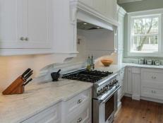 Traditional Kitchen With White Cabinetry and Marble Countertops