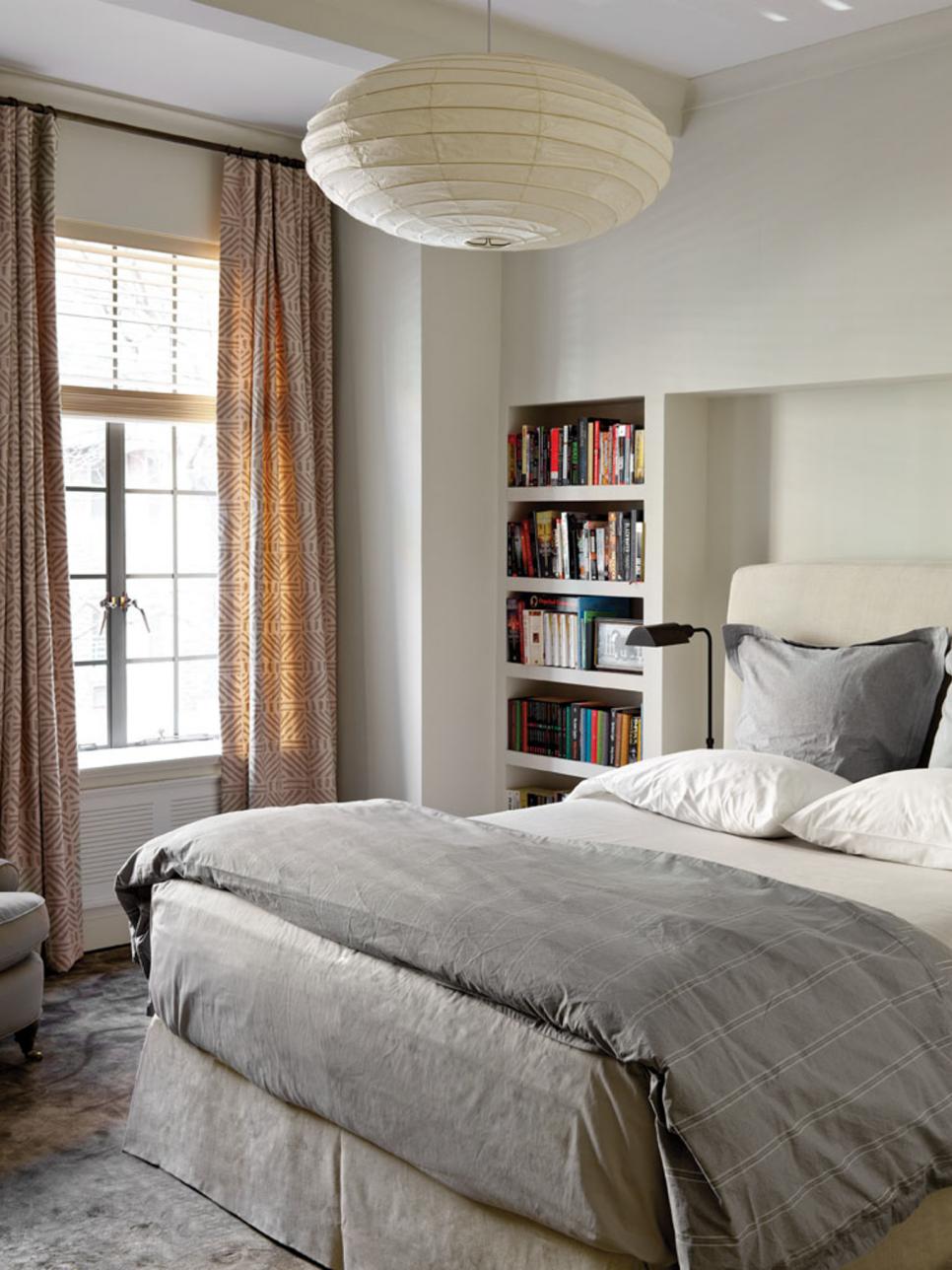 Contemporary bedroom with built-in bookshelf and paper lantern globe pendant light