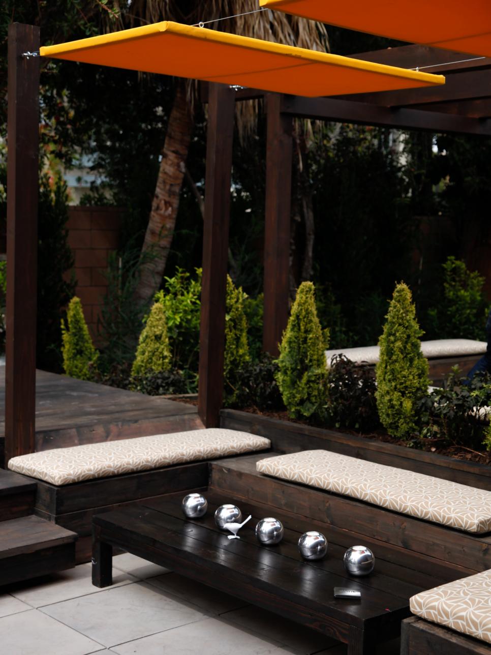 Sunken Patio with Built-In Seating, Pergola, and Orange Shades