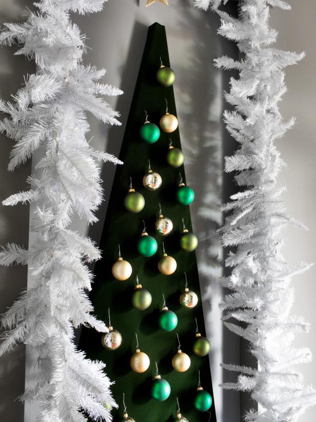 DIY Christmas tree from fiberboard and fabric with ornaments.