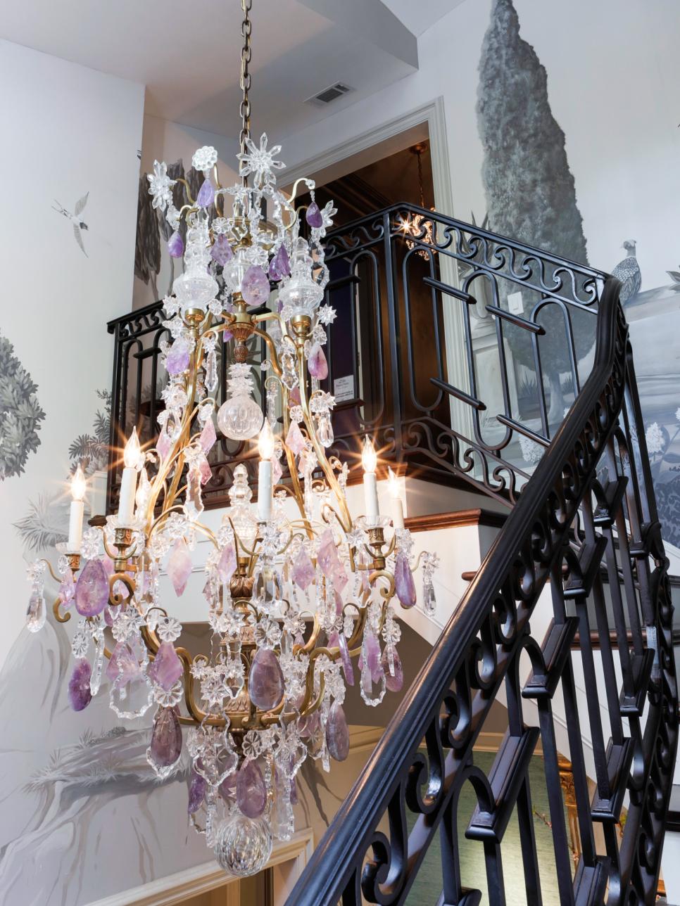 Stairwell with Chinoiserie Wall Designs and Chandelier Purple and crystal chandelier hanging over the stairwell