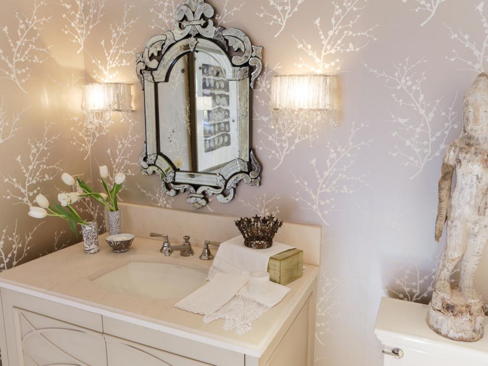 Beige Bathroom With Cream Vanity, Detailed Mirror and Wallpaper