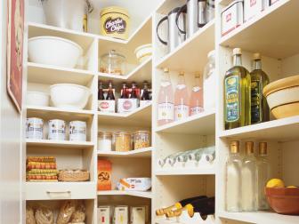 Pantry With White Shelves With Organized Canisters and Bottles