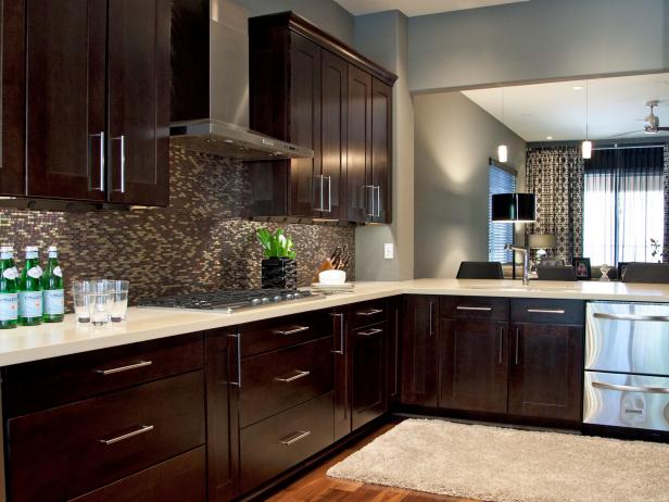 The client for this complete home renovation requested a luxurious, modern feel. The high-end kitchen remodel features warm walnut floors, dark espresso cabinetry and quartz countertops. Britany tied the look together with a modern glass and metal backsplash.