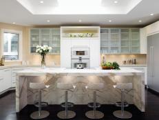 Contemporary White Kitchen With a Waterfall-Style Calacatta Marble Island 