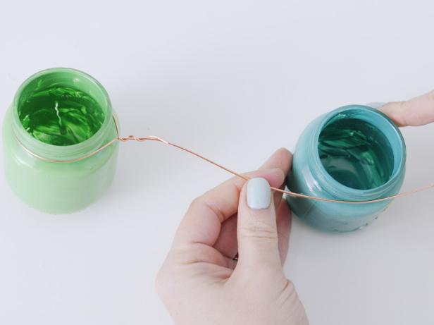 Take a large baby food jar in the same color family. About 5" from the first jar, wrap the wire around the large baby food jar. Move down the wire another 5" and wrap around the last small baby food jar in that color family. Twist the wire together to secure.