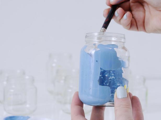 Mix the first section of paint until fully combined, then paint the inside of the largest jar. Repeat with the remaining two jars.