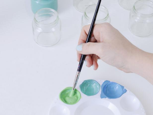 When painting the vases, mix the first section of paint until fully combined, then paint the inside of the largest jar. Repeat with the remaining two jars.