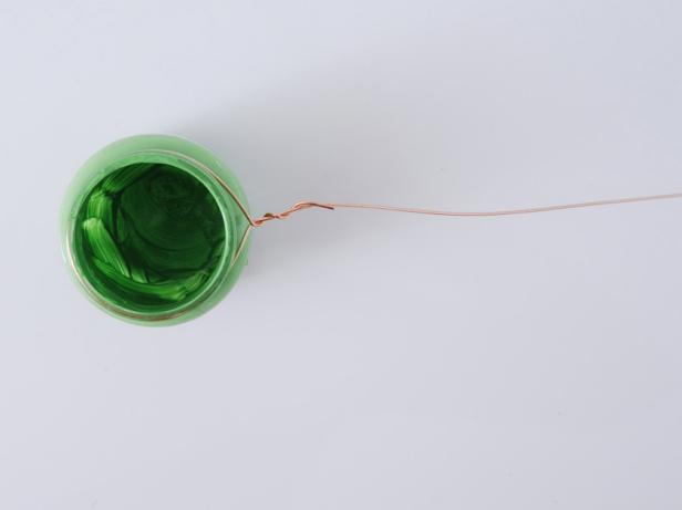 The three jars in the same color family will be wired together. Using wire cutters, cut a piece of copper wire 36" long. Wrap the end around a small baby food jar. Twist the end of the wire around the wire length.