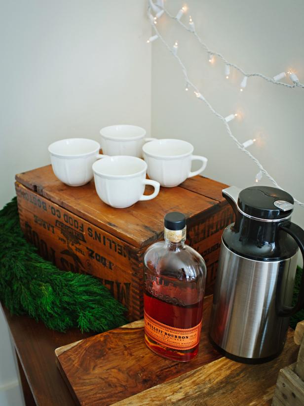 Drink station with mugs, thermos, and bourbon