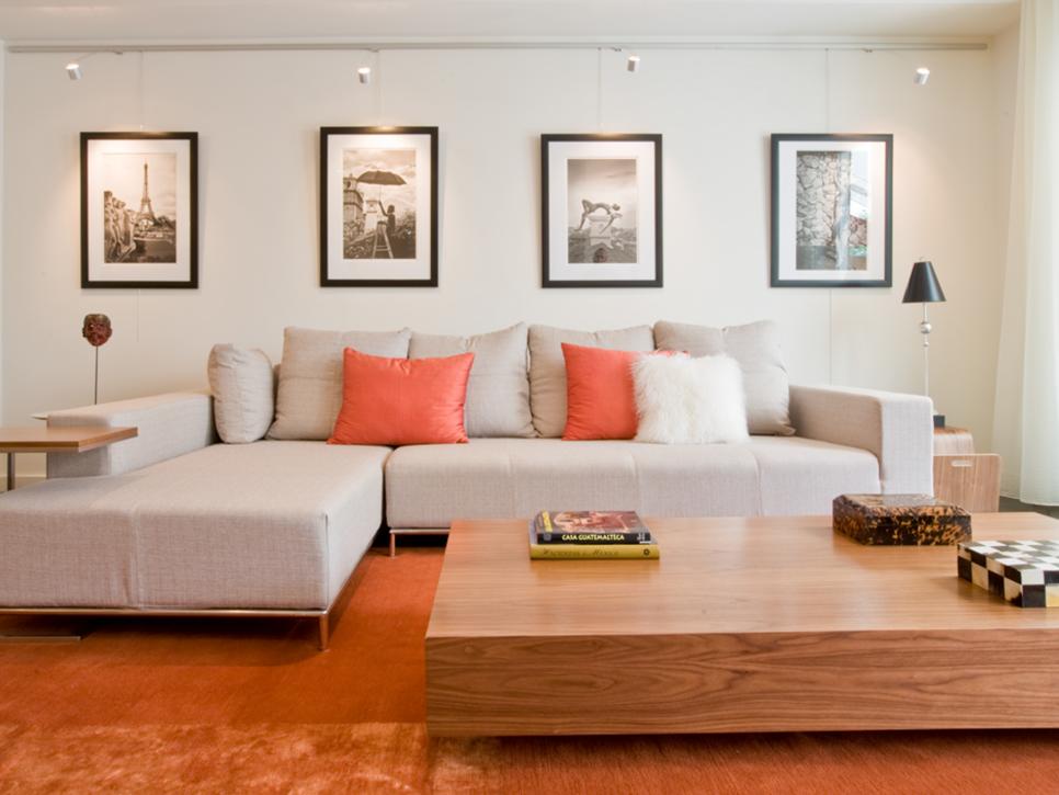 Living Space with Orange Accents and Framed Prints