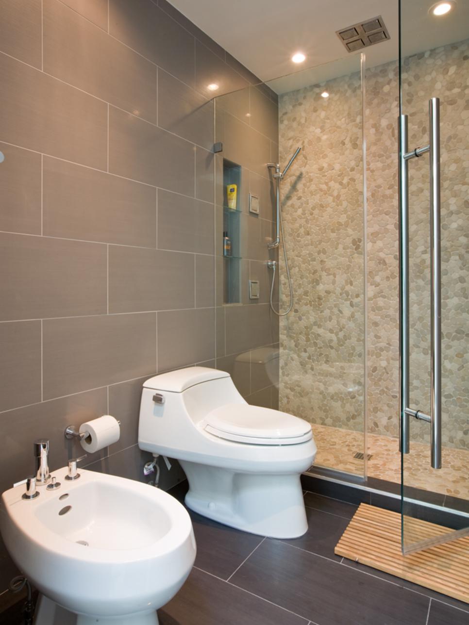 Gray Bathroom With River Rock Shower and Bidet