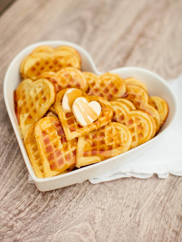 Wake up your loved one with fluffy, heart-shaped homemade waffles covered in sweet maple syrup.