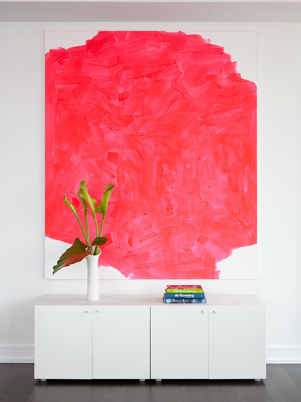 White Living Area With Pink Painting, White Credenza and Green Plant