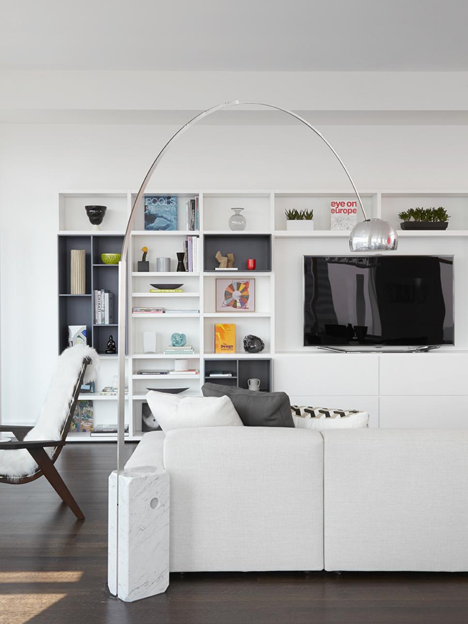 Sleek Living Room With Wall Storage and Metallic Floor Lamp