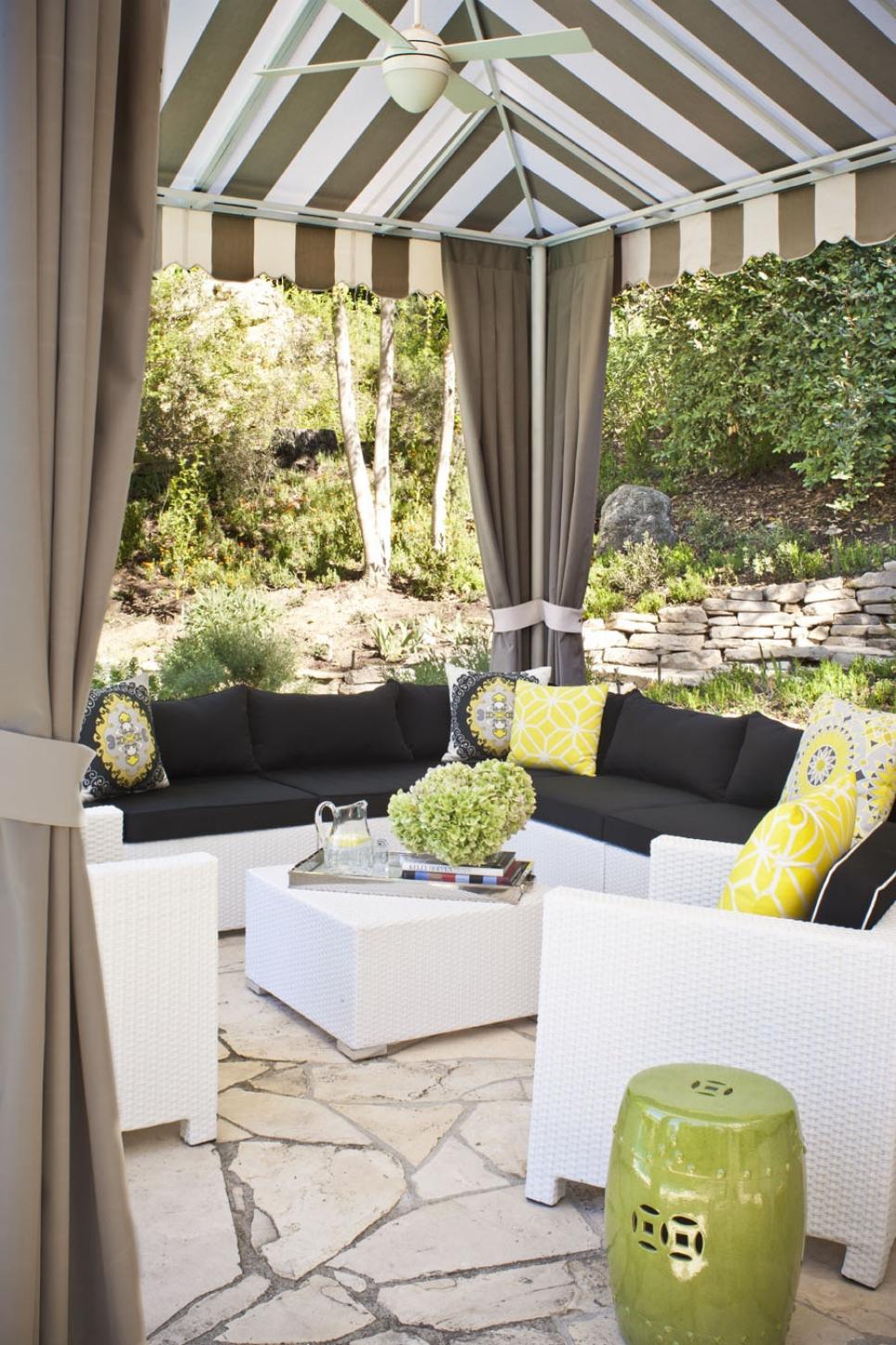 Comfortable, Casual and Contemporary Cabana Striped cabana with modular seating and bright, patterned pillows